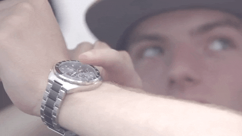 man pointing at his watch