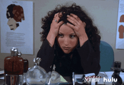 Elaine from the TV show Seinfeld looks stressed and has her head in her hands