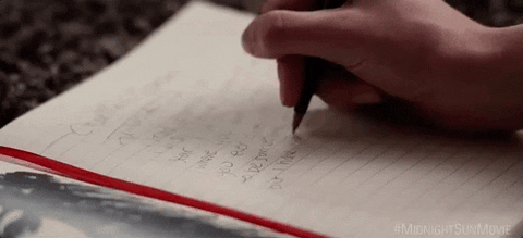 person writing in a notebook