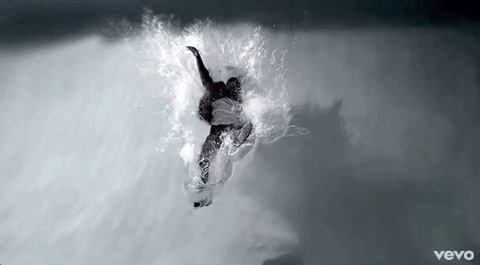 Black and white shot from Kendrick Lamar's Swimming Pools video, a figure plunging into water