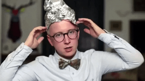 young man wearing a tinfoil hat because of 2020 conspiracy theories