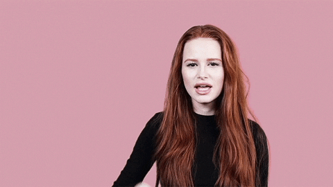 Madelaine Petsch, a woman with long red hair holding a remote control at a Quinceanera event.