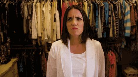 gif of a woman confused about what outfit she should wear 