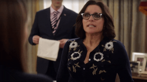 Selina Meyer from the TV show Veep making a "wrap it up" gesture