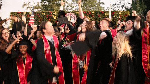 Graduation students throwing caps in the air.