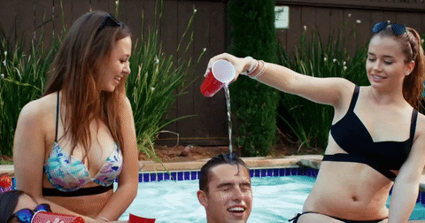 Woman pours water on a man in swimming pool