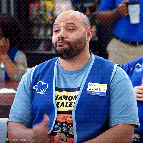 A GIF of Garrett from Superstore giving a thumbs up with a straight face.