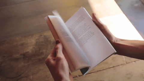 Person flipping the pages of a book.