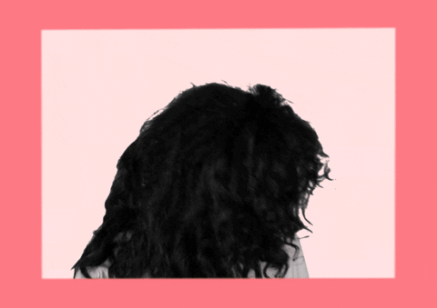 R&B singer SZA does a hair flip and leans back