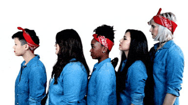 Five women dressed as Rosie the Riveter, flexing their arms