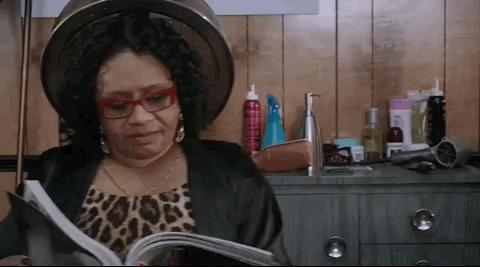 a GIF of Bruno Mars and a black woman sitting under a hair dryer from the video Uptown Funk