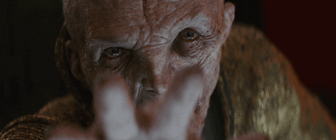 Snoke concentrating with two fingers raised in front of his face.