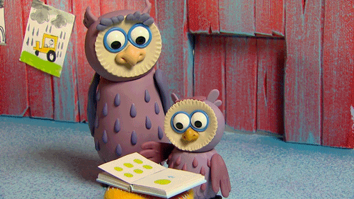 Mother and baby owl reading a book