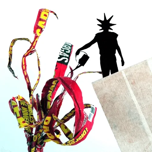 Silhouette beside curling ribbons of printed packaging paper