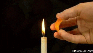Squeezing a orange peel onto a flame