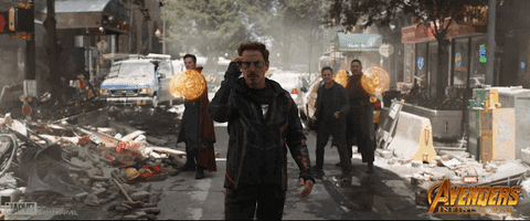 Avengers: Infinity War gif with Tony Stark taking off his sunglasses while Dr Strange, Wong, and Banner stand by a pile of debris behind him