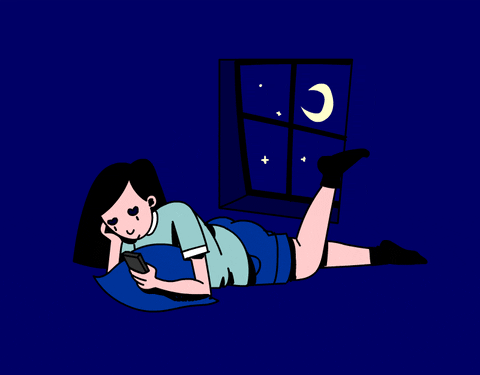 girl laying down scrolling through phone, while kicking her leg up and down, near window with crescent moon.