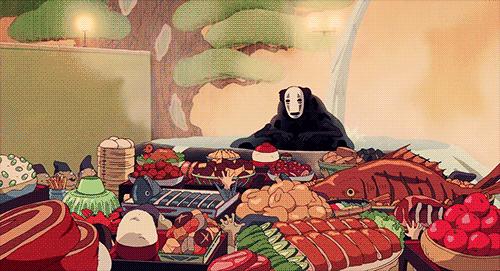 A gif from spirited away showing a celebratory banquet filled with various dishes.