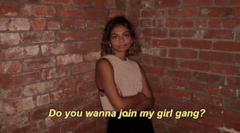 A gif of a women with the text "do you wanna join my girl gang?