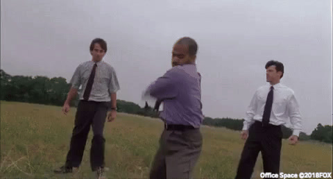 Office Space: three office workers in a field take turns smashing a printer with a baseball bat