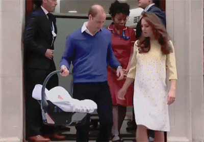 Prince William and Kate Middleton walking their baby out in a carrier. Prince William and Kate Middleton walking their baby out in a carrier.