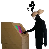 Masked figure pressing keys on a cardboard machine with a coloured screen
