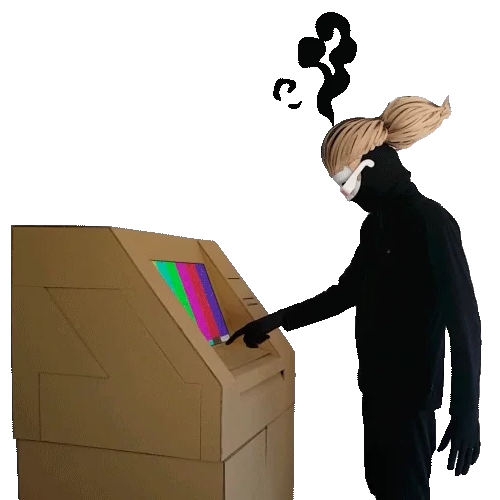 Masked figure pressing keys on a cardboard machine with a coloured screen