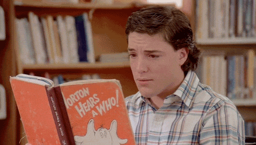 Man reading Dr. Seuss book Horton Hears a Hoot