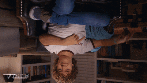 Moving image/GIF featuring actor Gaten Matarazzo, who plays Dustin Henderson on the TV show Stranger Things, speaking the following words to the camera: "That's it! THIS Upside Down." Gaten is seated in an armchair in front of a lamp and some bookshelves, and the entire image begins inverted upside down, as a visual joke. When Gaten says the words "That's it!," the camera un-inverts the image and the lights briefly go out before coming back on in a blueish hue, indicating that Gaten is in the Upside Down, a mysterious and malevolent alternate world from the TV show's universe. 