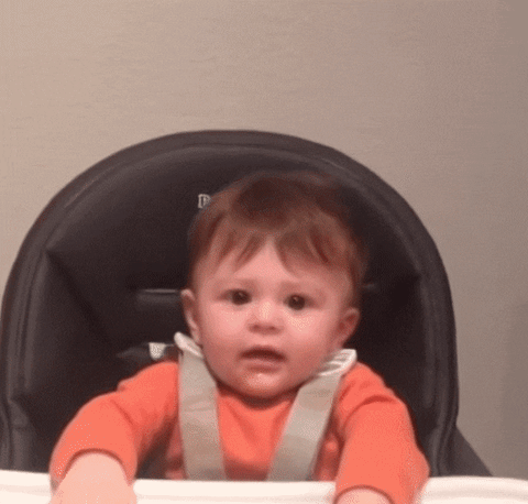 Gif of a baby putting both hands to the sky as if celebrating something