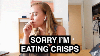 Animated GIF of young lady trying to work from home effectively by taking her break in front of the computer. She is caught on camera eating potato crisps. 