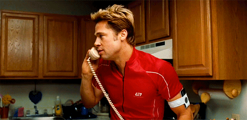 Brad Pitt from Burn After Reading, on phone laughing, reaction GIF