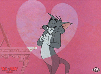 Gif of Tom from Tom and Jerry acting coy in front of an animated heart background