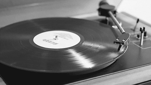 A vinyl record spins around on a turntable.