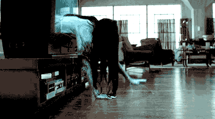 A GIF of a ghost crawling out of a television set.