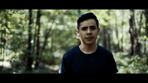 David Archuleta walking in the middle of the woods for a music video
