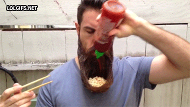 Hipster eating noodles out his beard shaped like a bowl with sirracha
