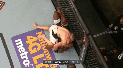 Derrick Lewis pushes off cage to get up from Viktor Pesta
