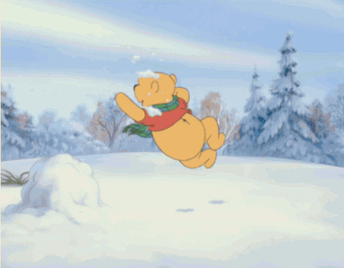 Winnie the Pooh dances around in the snow.