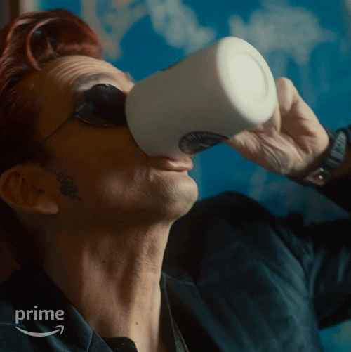 Crowley, as played by David Tennant, downing a cup of coffee