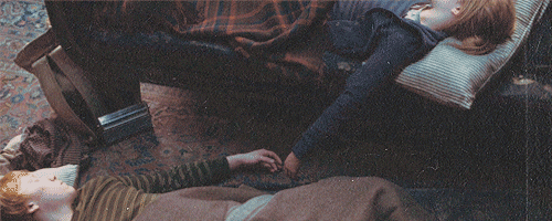 Hermione and Ron sleeping next to each other with their hands outstretched