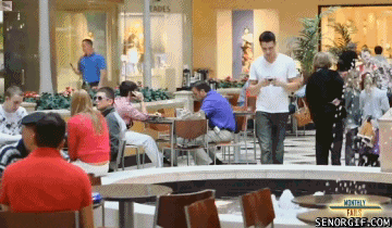 Guy falling into fountain while texting