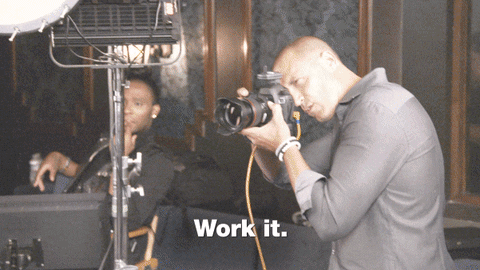 Gif of man shooting pictures and saying "work it"