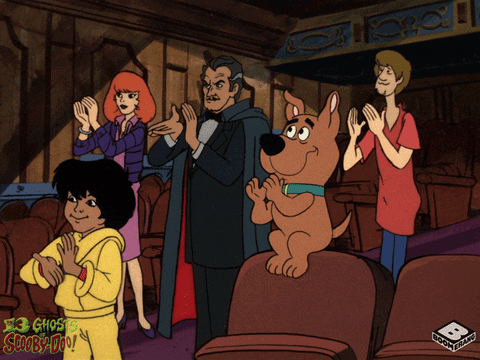 Five characters from Scooby-Doo give a standing ovation in a cinema.