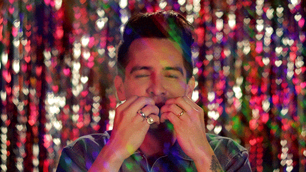 Brendon Urie blowing kisses and being showered in rainbow glitter