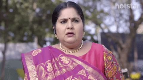 Woman wearing pink saree looking shocked via giphy