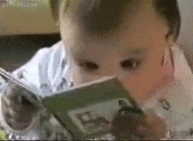 Small child reading a book up close