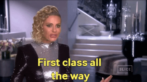 woman wearing sparkling clothes saying first class all the way