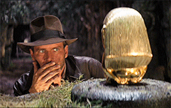 Harrison Ford in "Indiana Jones" studying treasure