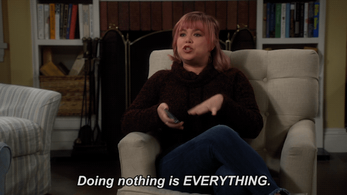 Giphy of women sitting on couch with caption doing nothing is everything